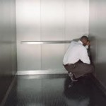 Guy Cowering In Elevator Corner